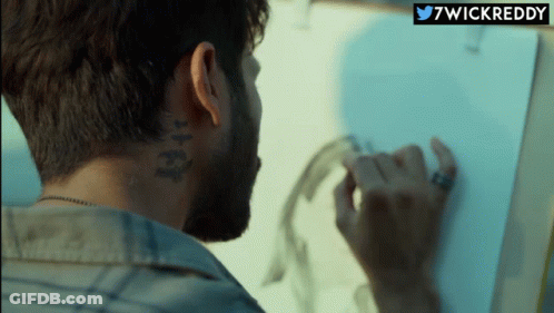 A Man With A Tattoo On The Back Of His Neck Is Drawing GIF