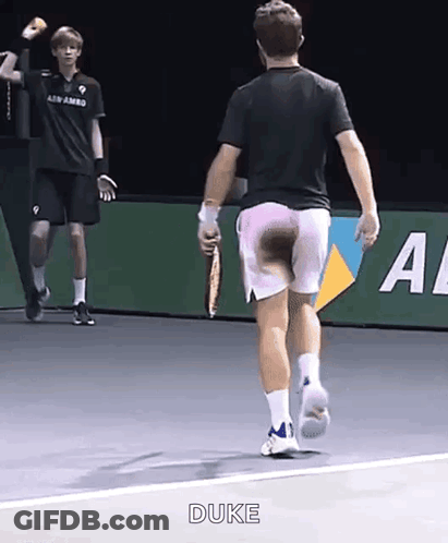 A Man With A Tennis Racquet Is Running On A Tennis Court And The Word Duke Is On The Bottom GIF