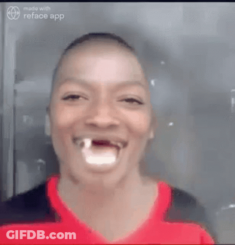 A Man With A Tooth Missing Is Laughing And Smiling . GIF
