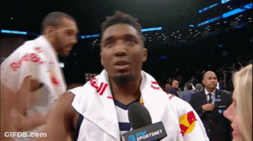 A Man With A Towel Around His Neck And A Microphone That Says At & T Sportsnet On It GIF