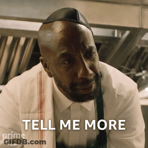 A Man With A Towel Around His Neck And The Words Tell Me More Above Him GIF