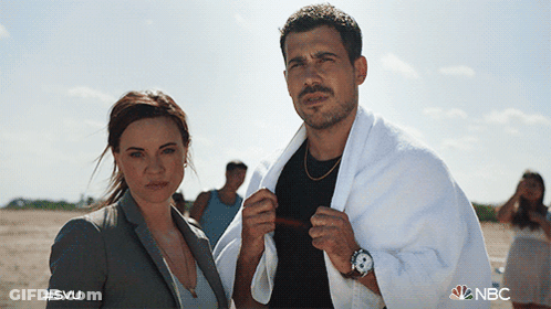 A Man With A Towel Around His Neck Stands Next To A Woman With #Svu On The Bottom GIF