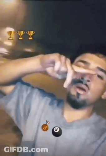 A Man With A Trophy And A Pool Ball In The Background GIF