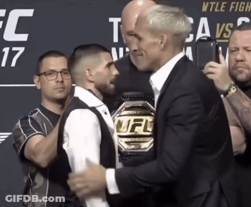 A Man With A Ufc Belt Stands Next To Another Man GIF