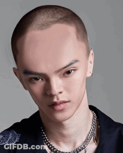 A Man With A Very Shaved Head And A Chain Around His Neck GIF