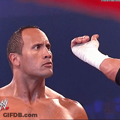 A Man With A W Logo On His Chest Is Being Punched In The Face GIF