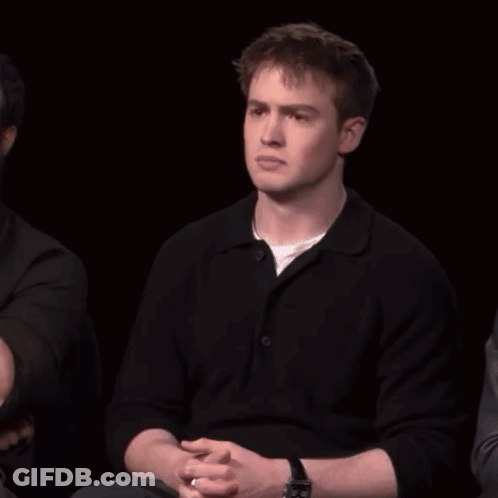 A Man With A Watch On His Wrist Is Laughing With His Mouth Open GIF