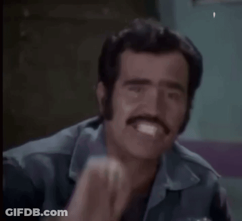 A Man With A Watch On His Wrist Is Making A Funny Face With His Fist . GIF