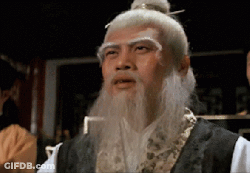 A Man With A White Beard And A Bun On His Head GIF