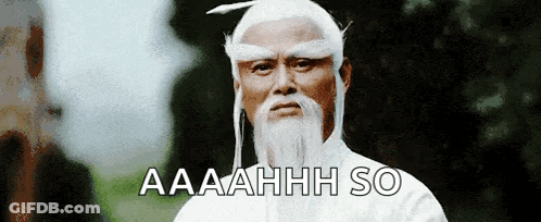A Man With A White Beard And A Feather In His Hair Says Aaahhh So GIF