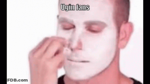 A Man With A White Face Is Cleaning His Nose . GIF