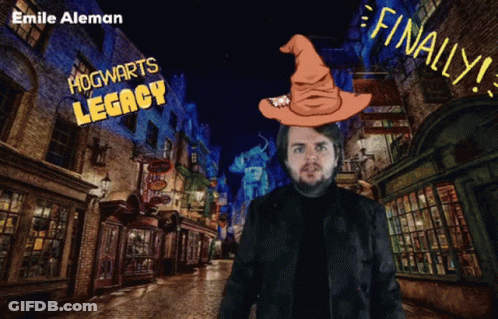 A Man With A Wizard Hat On His Head Stands In Front Of A Hogwarts Legacy Sign GIF