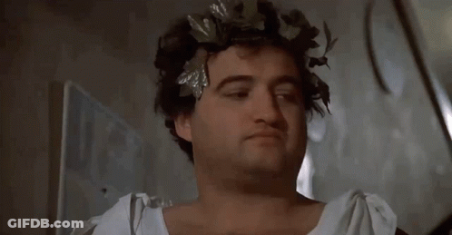 A Man With A Wreath Of Leaves On His Head Says Sorry GIF