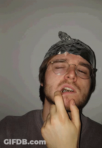 A Man With Aluminum Foil On His Head And Glasses GIF