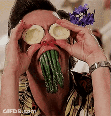 A Man With Asparagus Coming Out Of His Mouth And Sliced Potatoes On His Eyes . GIF