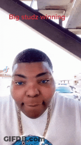 A Man With Big Studz Winning Written On The Top Of His Head GIF
