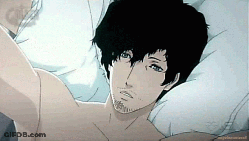 A Man With Black Hair And A Beard Is Laying In Bed . GIF