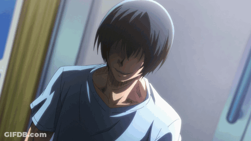 A Man With Black Hair And A Blue Shirt Is Standing In A Room GIF