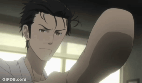 A Man With Black Hair And A White Shirt Is Looking At Something GIF