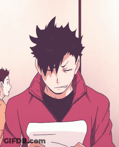 A Man With Black Hair Is Holding A Piece Of Paper In His Hand GIF