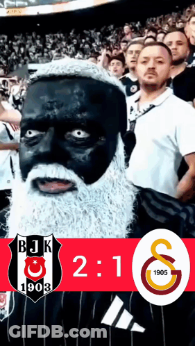 A Man With Black Paint On His Face And A White Beard Stands In Front Of A Bjk 1903 Logo GIF