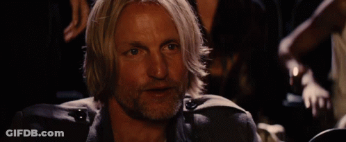 A Man With Blonde Hair And A Beard Is Holding A Bottle In His Hand GIF