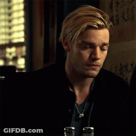 A Man With Blonde Hair And A Beard Is Sitting At A Table With Salt And Pepper Shakers In Front Of Him . GIF