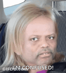 A Man With Blonde Hair And A Beard Is Sitting In A Car And Says I 'M Confused . GIF