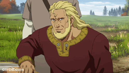 A Man With Blonde Hair And A Beard Wears A Red Shirt With Gold Trim GIF