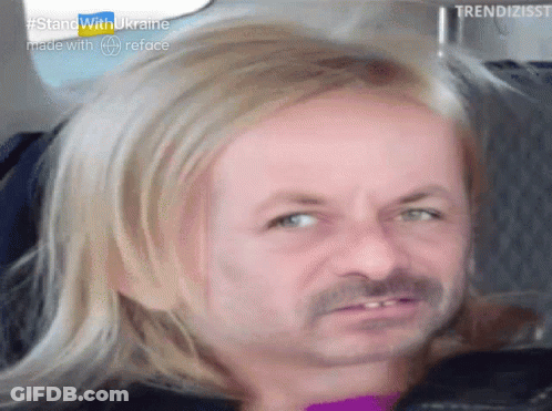 A Man With Blonde Hair And A Mustache Is Sitting In A Car . GIF