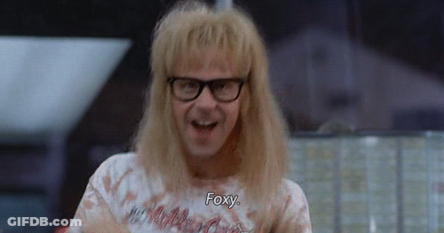 A Man With Blonde Hair And Glasses Is Wearing A T-Shirt That Says Foxy GIF