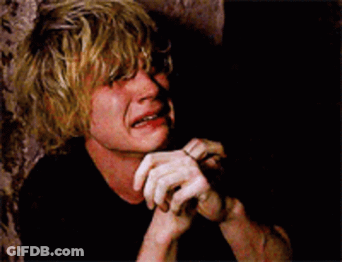 A Man With Blonde Hair Is Crying With His Hands On His Chin GIF