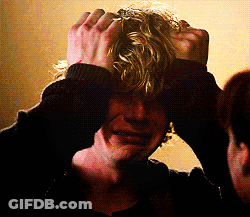A Man With Blonde Hair Is Holding His Hands To His Head And Crying GIF