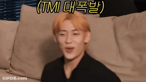 A Man With Blonde Hair Is Sitting On A Couch With A Foreign Language Written On The Bottom . GIF