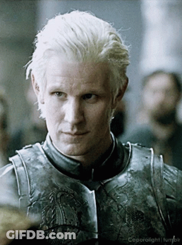 A Man With Blonde Hair Is Wearing A Knight 'S Armor And Is Looking At The Camera GIF