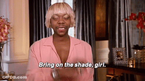 A Man With Blonde Hair Is Wearing A Pink Shirt And Saying `` Bring On The Shade Girl '' . GIF