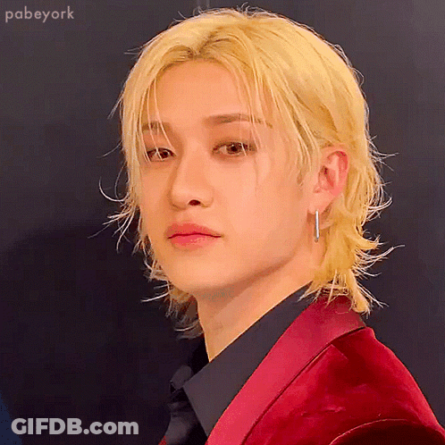 A Man With Blonde Hair Is Wearing A Red Jacket GIF