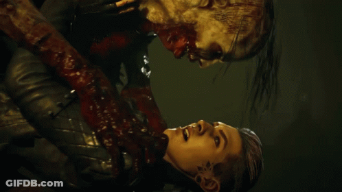A Man With Blood Coming Out Of His Mouth Is Holding Another Man GIF