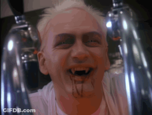 A Man With Blood Dripping From His Mouth And A White Shirt GIF