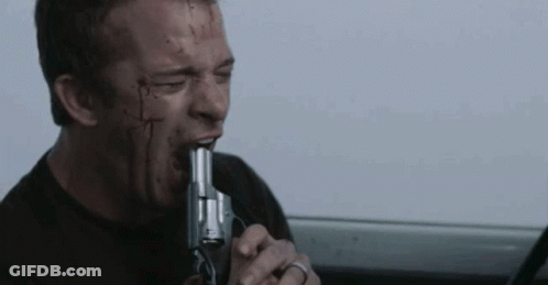 A Man With Blood On His Face Is Biting A Gun In His Mouth . GIF