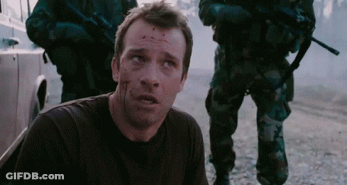 A Man With Blood On His Face Is Laying On The Ground In Front Of Soldiers GIF