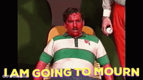 A Man With Blood On His Face Is Sitting In A Chair With The Words I Am Going To Mourn On The Bottom . GIF