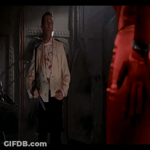 A Man With Blood On His Face Is Smiling And Looking At The Camera GIF