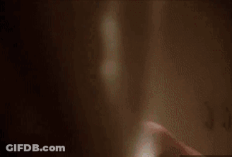 A Man With Blood On His Face Is Standing In A Locker Room . GIF