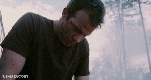 A Man With Blood On His Face Is Wearing A Black T-Shirt GIF