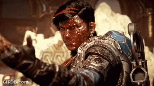 A Man With Blood On His Face Is Wearing A Blue Armor GIF