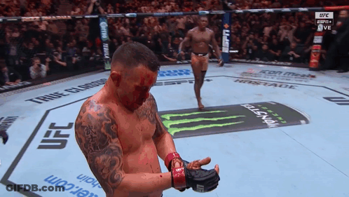 A Man With Blood On His Face Stands In A Ufc Boxing Ring GIF
