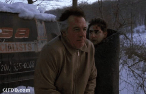 A Man With Blood On His Face Stands Next To Another Man In Front Of A Sign That Says " Sa Specialist " GIF