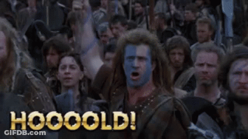 A Man With Blue And White Paint On His Face Is Screaming In Front Of A Crowd With The Words Hooooold On The Bottom GIF