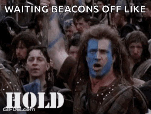 A Man With Blue And White Paint On His Face Is Standing In Front Of A Crowd Of People . GIF
